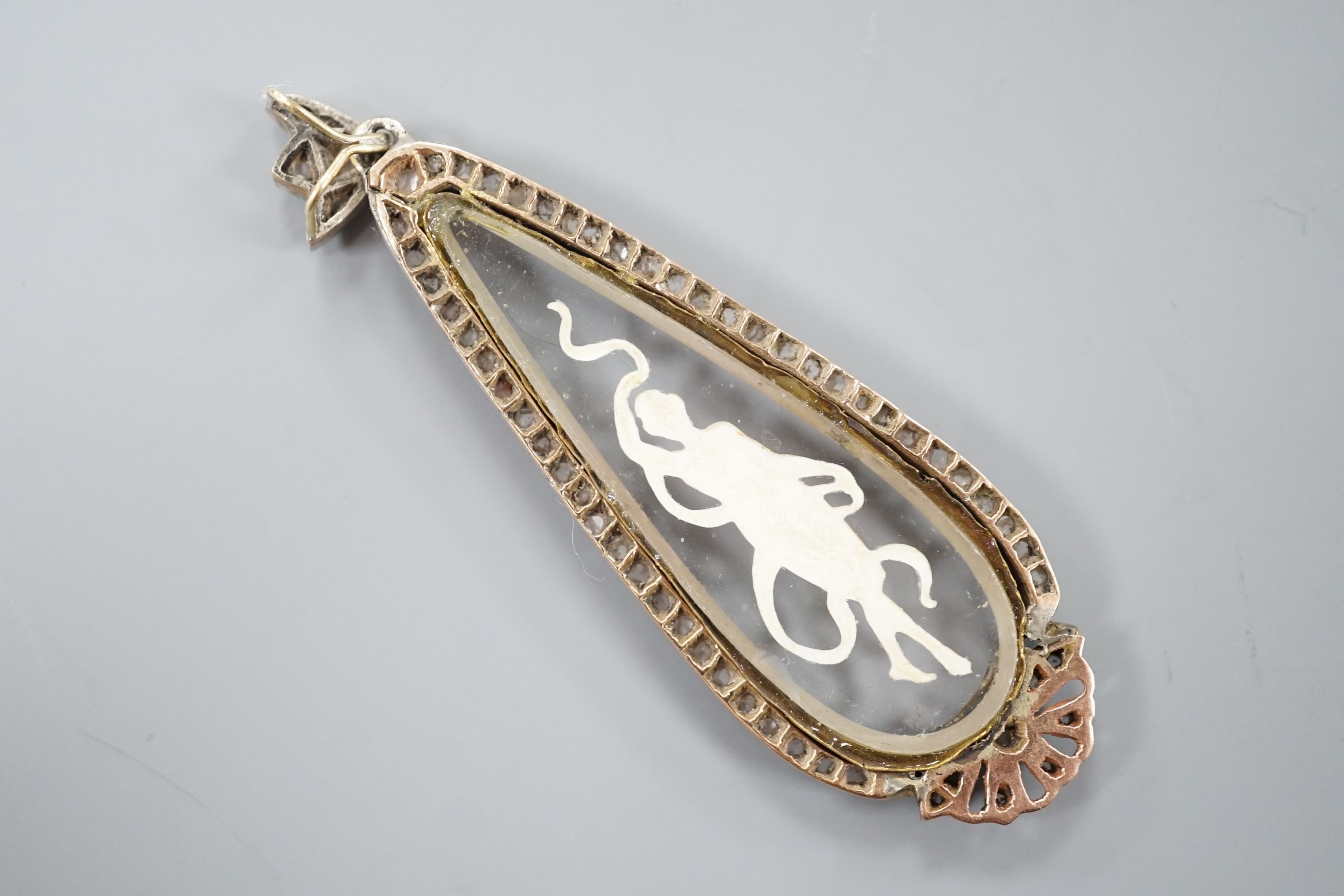 A Belle Epoque yellow and white metal, diamond and 'Essex crystal' style teardrop shaped pendant, decorated with a semi-clad maiden, 58mm, gross weight 6.3 grams.